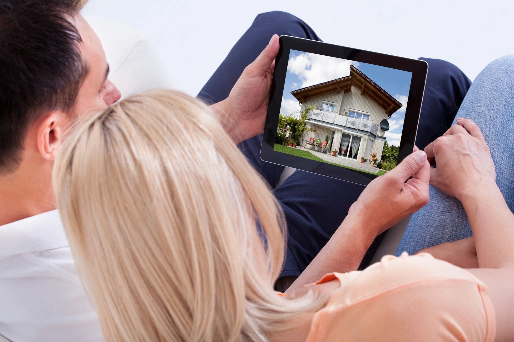 Pair looking at house photo on device