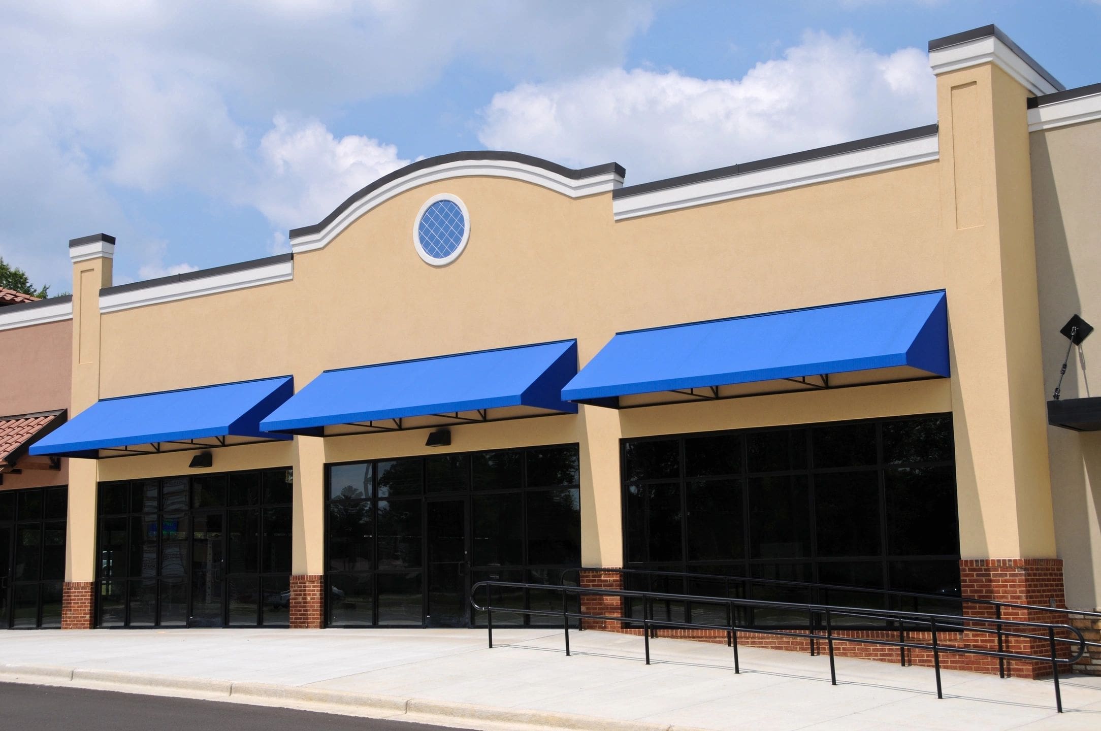 Beige building with blue awnings
