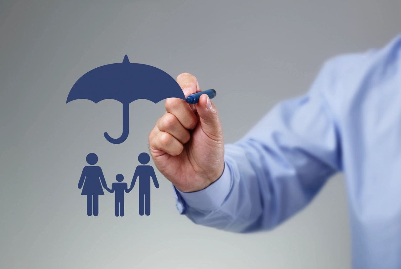 Hand drawing a family under an umbrella symbolizing protection.